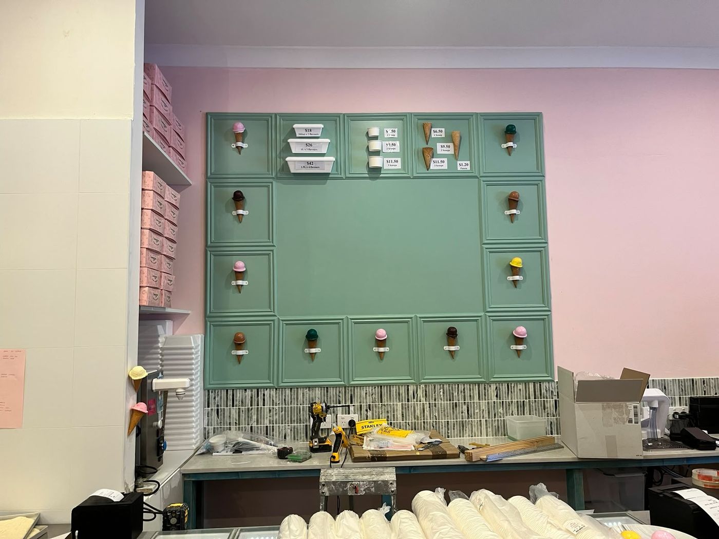 Finished sage green panelled display wall with ice cream cones and menu