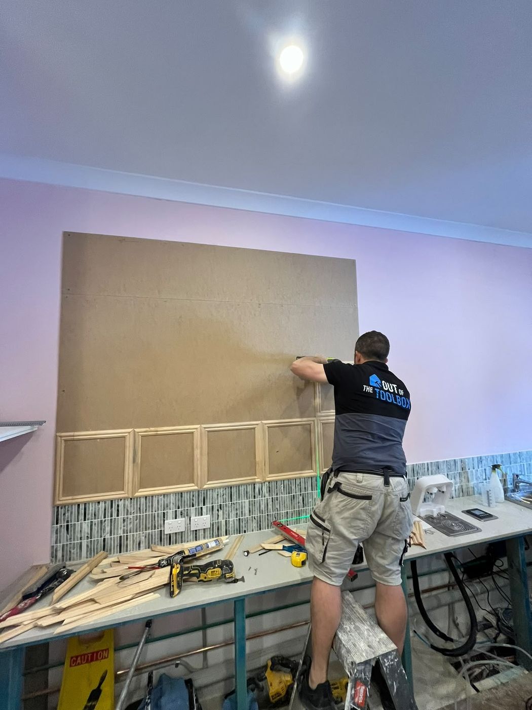 Moulding being fixed to the board to set out the panel grid
